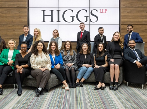 Group of seated trainee solicitors in front of a large screen