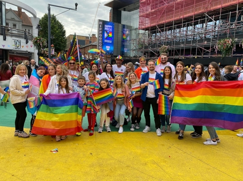 Crowd of people holding pride flags on a pride walk