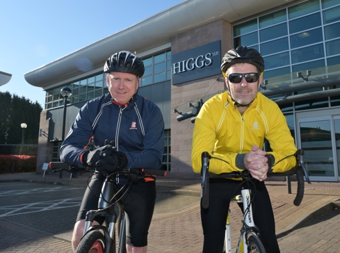 Two lawyers on push bikes wearing cycling clothing and sun glasses