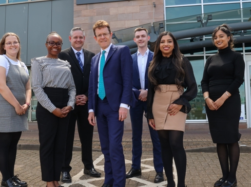 Group of trainee lawyers outside office with Birmingham Mayor